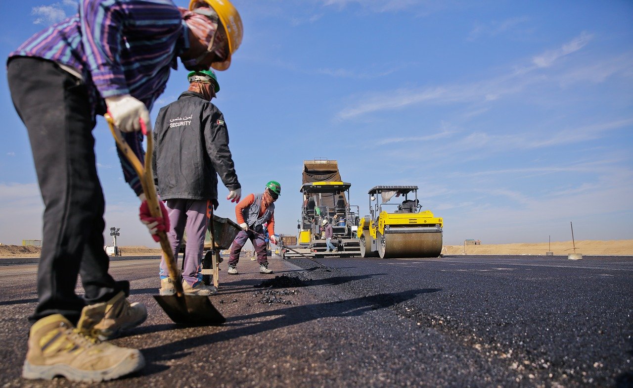 professional asphalt pavers installing new asphalt road